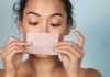 Oily Dehydrated Skin — The Hidden Truth Revealed Woman holding a skincare strip in front of her face