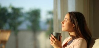 Woman enjoying a cup of coffee in a sunlit room