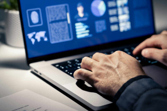 shutterstock2376208003jpg Close-up of hands typing on a laptop with data visualizations on the screen