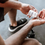 Person pouring probiotic pills into their hand