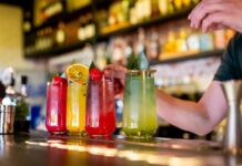 Gen Z’s Anti-Alcohol Movement Reshapes Bars A bartender preparing colorful cocktails at a bar