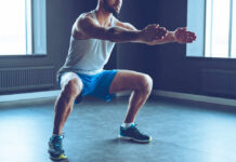 Man performing a squat exercise in a gym