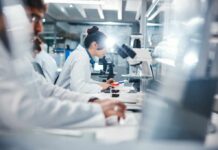 New Drug Discovery Halts Vision Loss in Its Tracks Scientists working in a laboratory with microscopes and test tubes