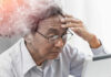 The Mystery Behind Brain Fog Elderly man looking stressed while using a digital device