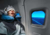 Too Much Sleep? Dementia Warning! A passenger sleeping on an airplane with headphones and an eye mask