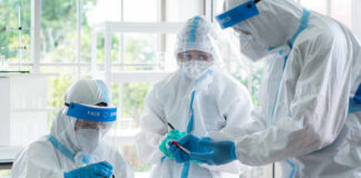 Scientists in protective suits conducting research in a laboratory