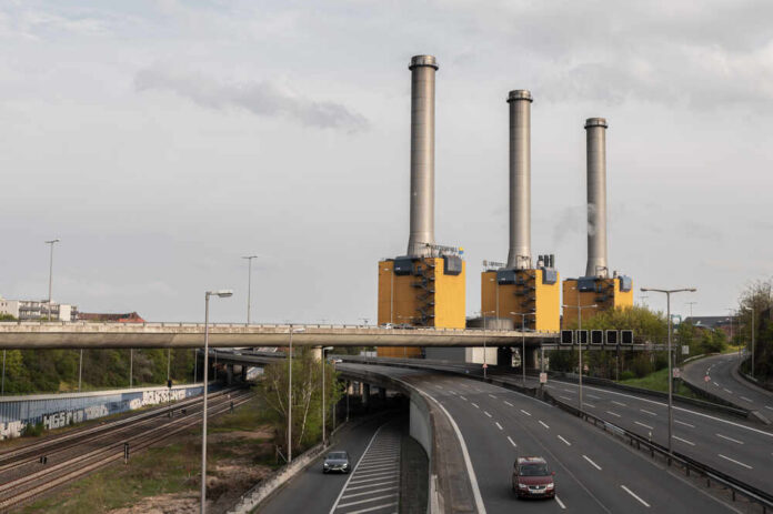 Berlin,-,Germany,,May,01.2021:,Wilmersdorf,Thermal,Power,Station,With Industrial power plant with three tall smokestacks beside a highway