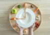 Heart Disease Risk Lowered By Phytosterol-rich Foods Hands holding a white plate surrounded by fresh vegetables and an egg