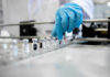 Blood Clue That Flags Blindness Years Early A healthcare professional in a lab preparing vaccine vials
