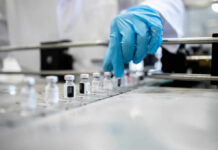 Blood Clue That Flags Blindness Years Early A healthcare professional in a lab preparing vaccine vials
