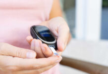 The Overlooked Plant Compound That Cuts Blood Sugar Person using a blood glucose meter to check their levels