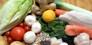 Assorted fresh foods including vegetables, grains, eggs, fish, and chicken