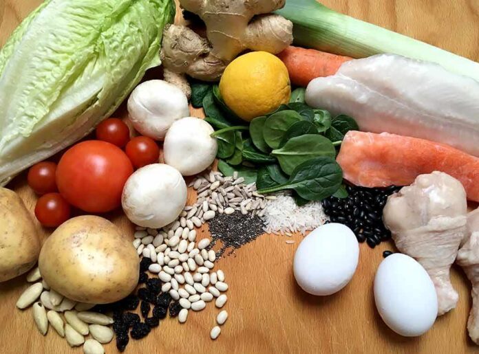 Assorted fresh foods including vegetables, grains, eggs, fish, and chicken