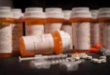 Heart-Stopping ED Pills Invade Britain Various prescription medication bottles and syringes on a table