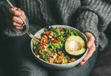 Healthy Eaters Blindsided By Hidden Sprays A person holding a bowl of colorful salad with avocado and greens