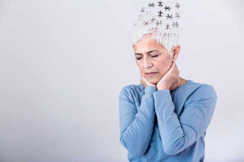 Memory,Loss,Due,To,Dementia.,Senior,Woman,Losing,Parts,Of Elderly woman with a unique hairstyle made of puzzle pieces, looking thoughtful