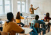 Teacher explaining a math concept to students in a classroom