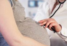 Early Births, Massive Cancer Drop! Pregnant woman examined with stethoscope