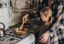 Kitchen Reheat Mistake Creates Cancer Chemicals Child cooking with adult at a stove