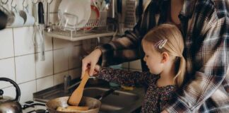Child cooking with adult at a stove