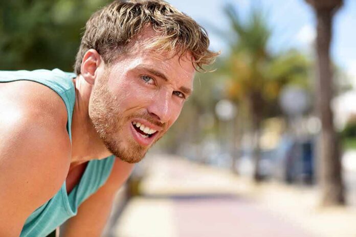1783890440440-ay5ovv-shutterstock-1017406066 man in athletic tank top resting outdoors
