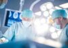 Old Man Disease Ambushes Young Men Surgeons in operating room under bright surgical lights
