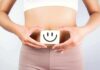 IBD’s Sneakiest Damage Isn’t In The Gut torso of person holding smiley card over stomach