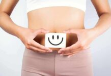 IBD’s Sneakiest Damage Isn’t In The Gut torso of person holding smiley card over stomach