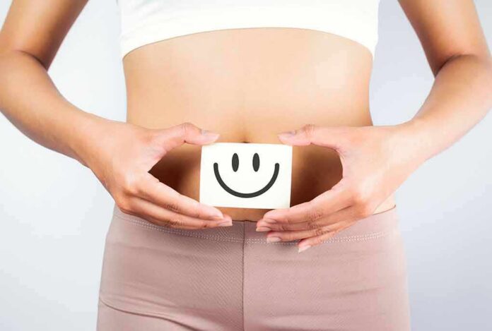 shutterstock_1276561783 torso of person holding smiley card over stomach