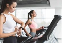 Diet Drops Pounds, Exercise Keeps Them Dead Woman on treadmill checking smartwatch in gym