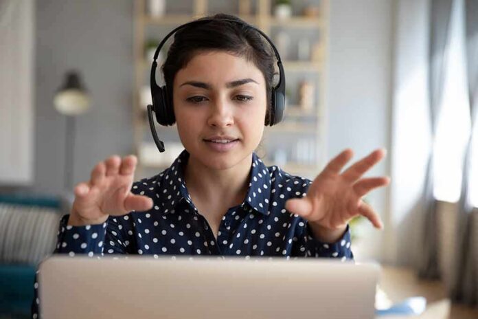 shutterstock_1606120399 Woman wearing headset on video call