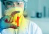 New Cancer Breath Test Shocks Oncologists Scientist holding a test tube with red liquid