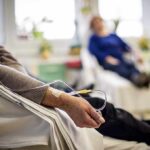 Patient arm with IV line in a hospital chair