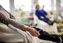 Patient arm with IV line in a hospital chair