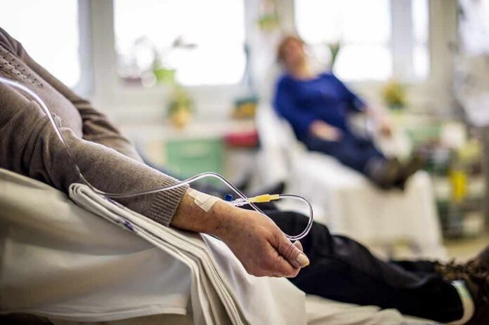 Patient arm with IV line in a hospital chair