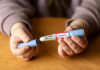 Blindness Claims Explode Against Weight-Loss Shots Hands holding an Ozempic injection pen.