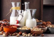 Anti-Aging Milk? Scientists Stunned Glass bottles of milk surrounded by assorted nuts in bowls