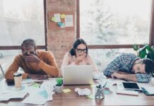 How To Quickly Recover From A Bad Night’s Sleep tired coworkers at a cluttered desk