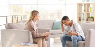 Teen talking with therapist in a bright office