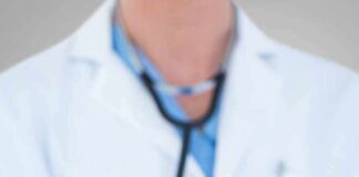 Doctor holding stethoscope with pink ribbon in front