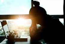 FDA-Approved Trial Delivers Jaw-Dropping Depression Breakthrough silhouetted person at a desk with head in hands