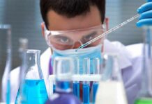 The impact of dietary emulsifiers on gut health Scientist pipetting blue liquid into test tubes