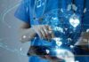 Healthcare professional using a digital tablet with medical data icons