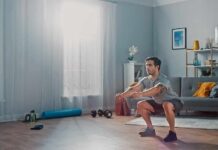 Man doing bodyweight squats in a living room