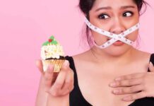 Mindful Eating Interventions for Obesity Management Woman with measuring tape over mouth holding a decorated cupcake