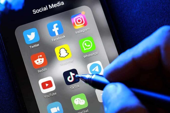shutterstock_1907235274 Smartphone screen showing social media app icons