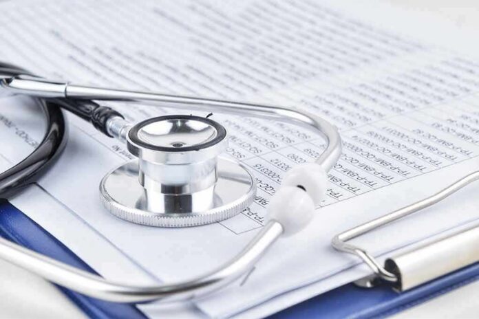 Stethoscope on medical documents and clipboard