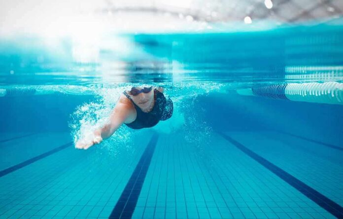 shutterstock_2328320555 swimmer underwater in a lane pool