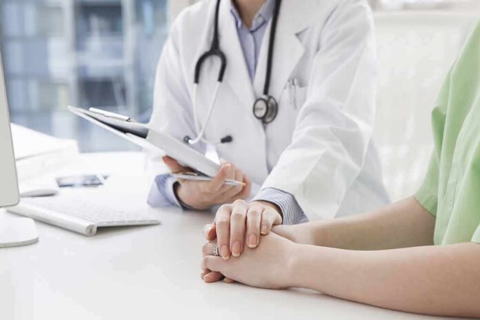 Doctor holding a patient's hands during consultation