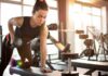 Best Grip Strength Training Guide for Everyday Function Woman performing dumbbell row in a gym